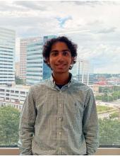 Surendra Anne A young man with curly hair smiling.
